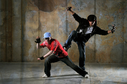 Two hip-hop dancers performing with a grungy background